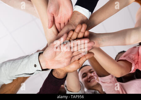 Multi-ethnic Group Of People Stacking Hand Showing Unity Stock Photo