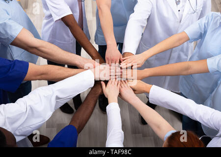 Directly Above Shot Of Medical Team Stacking Hands Together At Hospital Stock Photo