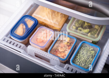 Stacked Of Plastic Containers With Various Food Store In Refrigerator Stock Photo