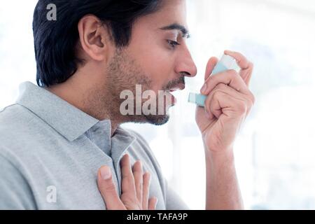Man using inhaler Stock Photo
