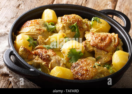 Popular spicy chicken coconut curry with potatoes close-up in a pan on the table. horizontal Stock Photo