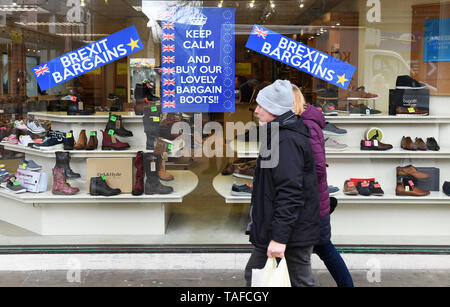 A shop window with blue Brexit signs saying, Brexit Bargains and Keep Calm and Buy Our Lovely Bargain Boots in a UK high street. Stock Photo