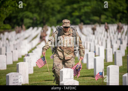 Arlington, VA, USA. 23rd May, 2019. Soldiers assigned to the 3d U.S. Infantry Regiment (The Old Guard) place US flags on graves at Arlington National Cemetery on May 24, 2018 ahead of Memorial Day in Arlington, Virginia. Credit: Michael A. McCoy/ZUMA Wire/Alamy Live News Stock Photo