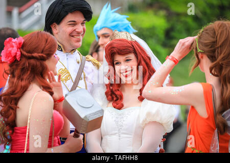 ExCel London, UK - 24th May 2019. A gaggle of princesses (and one prince) clearly enjoy the afternoon. Thousands of cosplayers, gamers and lovers of film and TV fantasy and sci fi in costumes come together on the opening day of MCM Comicon at ExCel London. Credit: Imageplotter/Alamy Live News Stock Photo