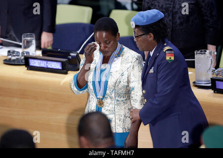 New York, USA. 24th May, 2019. Chitete Mwenechanya (L), who wears around her neck the medal awarded to her late husband, wipes her tears during a ceremony at the UN headquarters in New York, May 24, 2019. A Malawian soldier, who gave his life to save a comrade-in-arms in a UN operation in the Democratic Republic of Congo (DRC) in November 2018, was posthumously awarded the highest and most prestigious recognition for UN peacekeeping on Friday. The Captain Mbaye Diagne Medal for Exceptional Courage was awarded to Private Chancy Chitete. Credit: Xinhua/Alamy Live News Stock Photo