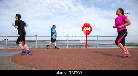 Morecambe, Lancashire. 25th May, 2019. UK Weather: Bright and sunny in the north-west Morecambe resort as 10 k runners pound the promenade on their early morning charity run.  The Morecambe 10km is popular with new runners and PB hunters alike! Starting and finishing on the Promenade this seaside race provides a good course coupled with lovely views across the Bay to the Lake District. Credit; MediaWorldImages/AlamyLiveNews Stock Photo