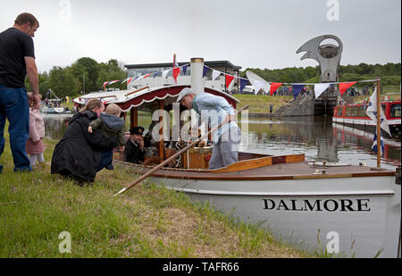 Falkirk, UK. 25th May, 2019. UK. Re-opening of the Forth and Clyde Canal celebrations beginning at The Falkirk Wheel a flotilla of steam boats, puffers, rowing boats and more had a dry weather start. Which was held back slightly by the Maryhill having to be towed away from smaller vessels by the Dalmore. The journey takes the vessels through Bonnybridge to final destination at Auchinstarry Marina. Stock Photo