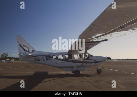 Maun, Botswana, October 2014: Cessna aircrafts standing parked at the tarmac of the local airport during sunrise Stock Photo