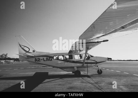 Maun, Botswana, October 2014: Cessna aircrafts standing parked at the tarmac of the local airport during sunrise Stock Photo