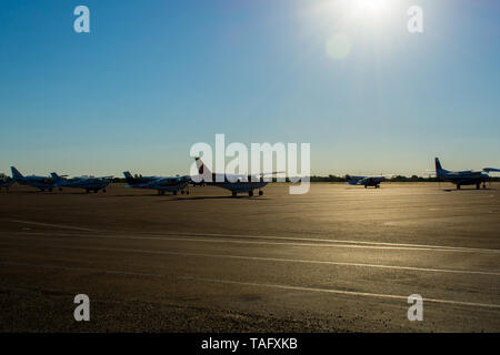 Maun, Botswana, October 2014: Cessna aircrafts standing parked at the tarmac of the local airport during sunrise Stock Photo