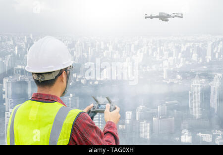 Drone operated by construction worker on building site Stock Photo