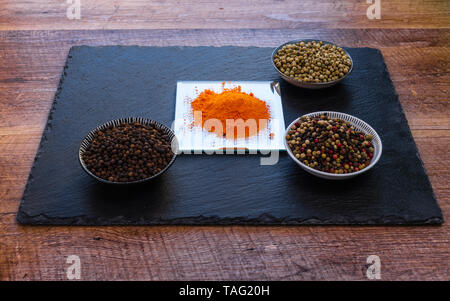 Grain Spices on bowls on wooden table Stock Photo