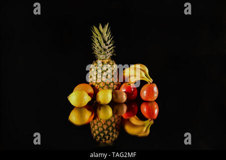 Fresh fruits reflect on black background. Isolated fruits Stock Photo