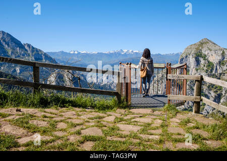 Young woman enjoying a breathtaking view from Santa Catalina Lookout overlooking La Hermida Gorge in Cantabria, Spain Stock Photo
