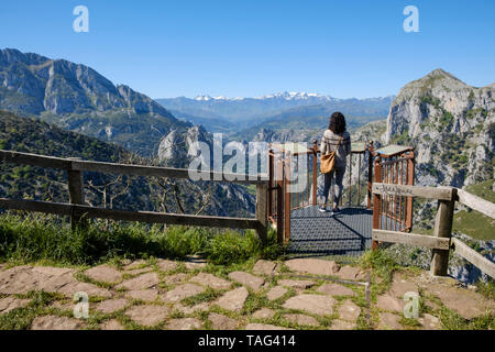 Young woman enjoying a breathtaking view from Santa Catalina Lookout overlooking La Hermida Gorge in Cantabria, Spain Stock Photo