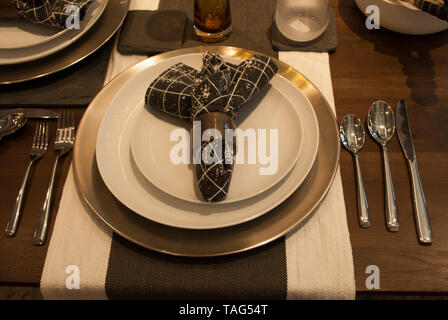 Dinner table. Serving set. Set of tableware. Served table. Dishes, napkins, forks, spoons, glasses on the table close up Stock Photo