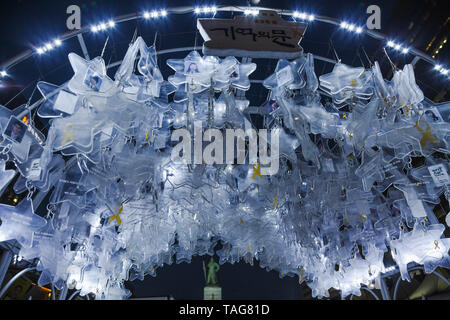 The photograph of Sewol ferry victims in star shaped frames are memorized and illuminated in a night sky at Gwangwamun Square, Seoul, South Korea. Stock Photo