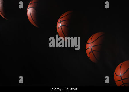 Stroboscopic photo of moving ball on dark background Stock Photo