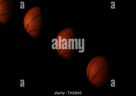 Stroboscopic photo of moving ball on dark background Stock Photo