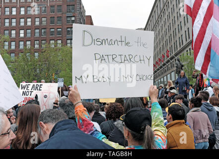 A women's rights rallygoer holds a sign stating 'Dismantle the Patriarchy My Body My Choice' in downtown Cleveland, Ohio, USA on May 21, 2019 Stock Photo