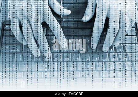 Closeup of hands on laptop keyboard in binary data Stock Photo