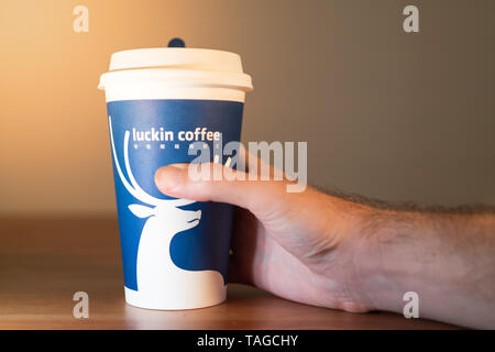 11 May 2019, Wuhan Hubei China : Man hand holding a Luckin Coffee cup Stock Photo