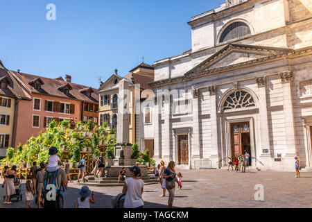 7 August 2018, Annecy France : Tourists in the street of old Annecy city with the facade of church Notre Dame de Liesse in Annecy France Stock Photo