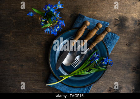 Spring table setting with blue scilla siberica flowers on concrete background with copy space Stock Photo