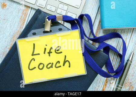 Life coach badge with keyboard on a wood. Stock Photo