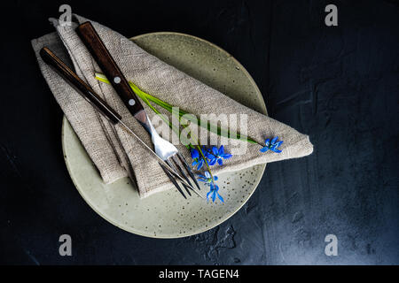 Spring table setting with blue scilla siberica flowers on concrete background with copy space Stock Photo