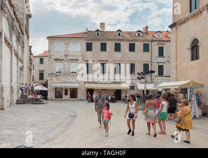 DUBROVNIK, CROATIA - AUGUST 13, 2015: Summer scene of the streets in Dubrovnik with locals and tourists. Streets of Dubrovnik are now used as set for  Stock Photo