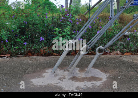 The sling pins are embedded in the cement for stability and strength. Stock Photo