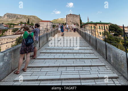 MOSTAR, BOSNIA AND HERZEGOVINA - JULY 13, 2016: Tourists on the Old Bridge 'Stari Most'. It was built in 1557 by Ottomans. Old Bridge is inscribed on  Stock Photo