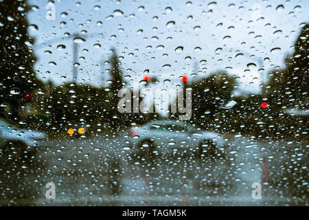 Cars driving through rain; raindrops on the windshield Stock Photo