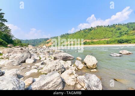 Picturesque View of River Banks and Green Mountains in the Countryside of Nepal Stock Photo