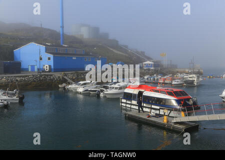 Marina and port facilities at Paamiut Village on the west coast of Greenland. Tendering boats operating from a visiting cruise ship. Stock Photo