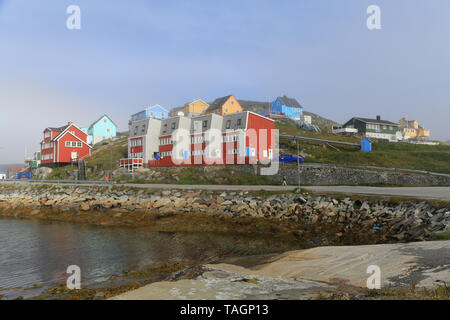 Marina and port facilities at Paamiut Village on the west coast of Greenland. Passengers from a visiting cruise ship are on a walking tour. Stock Photo