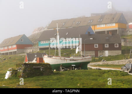 Fishing boat Dina, built in Denmark in 1948, arrived in the village of Paamiut on the west coast of Greenland in 1949. Turf house for winter use. Stock Photo