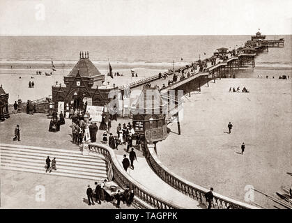 A late 19th Century view of Skegness pier opened on Whit Monday in June 1881 by the Duke of Edinburgh Alfred, Duke of Saxe-Coburg and Gotha and was at the time the fourth longest in England, at a length of 614 yards (561 m) long. Skegness is a seaside town  on the Lincolnshire coast of the North Sea, England, Stock Photo