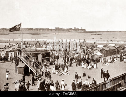 A late 19th Century view of fair ground attractions on the beach in South Shields, an industrial coastal town County Durham, in the North East of England. Located at the mouth of the River Tyne in became a popular tourist resort towards the end of the century. Stock Photo