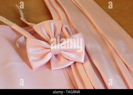 Men's wear ready for a formal event, pink satin bowties and neck ties Stock Photo