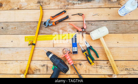 Above view of mixed hardware stuffs on a wood table maded by recycled pallets. do it yourself repair and contruct furnitures like hobby concept - raw  Stock Photo
