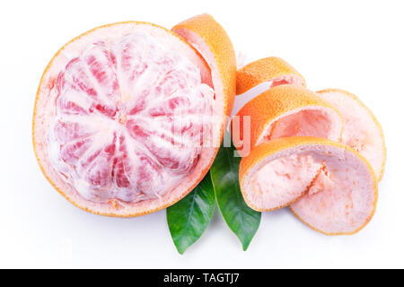 Peeled grapefruit with green leaves isolated on white background. Stock Photo