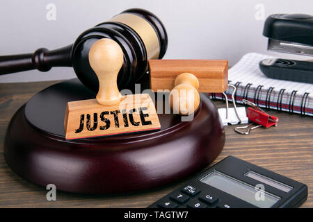 Justice concept. Judge gavel and stationery on a wooden table Stock Photo