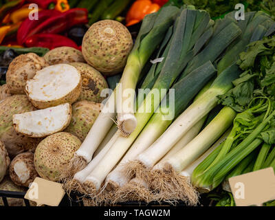 Close up view on fresh organic celery and leel and other vegetables at a market Stock Photo