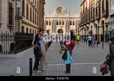 Lima, Peru - April 21, 2018: Woman with baby selling goods to tourists outside Casa de la Literatura Peruana which translates to House of Peruvian Lit Stock Photo