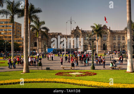 Lima, Peru - April 21, 2018: View of main square and Government Palace on sunny afternoon with many tourists Stock Photo