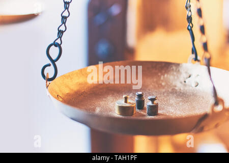Tiny weights on vintage balance scales