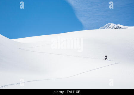 A man skins up the Asulkan Glacier to the Seven Steps to Paradise ski run the backcountry of Glacier National Park, British Columbia. Skier in the Can