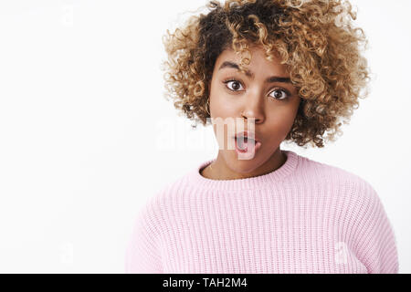 You say what. Portrait of stylish and cool charismatic african-american woman with blond curly hair open mouth and raise eyebrow looking funny and Stock Photo